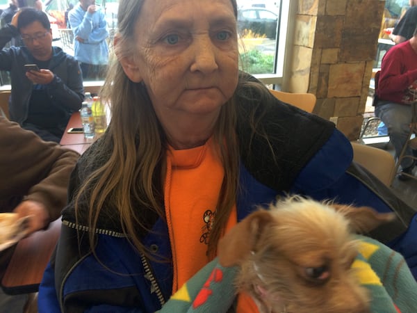 Teresa Goff-Tater of Gatlinburg said she lost her home in the fires. She is seen here with her dog at the shelter set up at Rocky Top Sports World recreation center in Gatlinburg, Tenn. on Wednesday, Nov. 30, 2016. (Craig Schneider / cschneider@ajc.com)