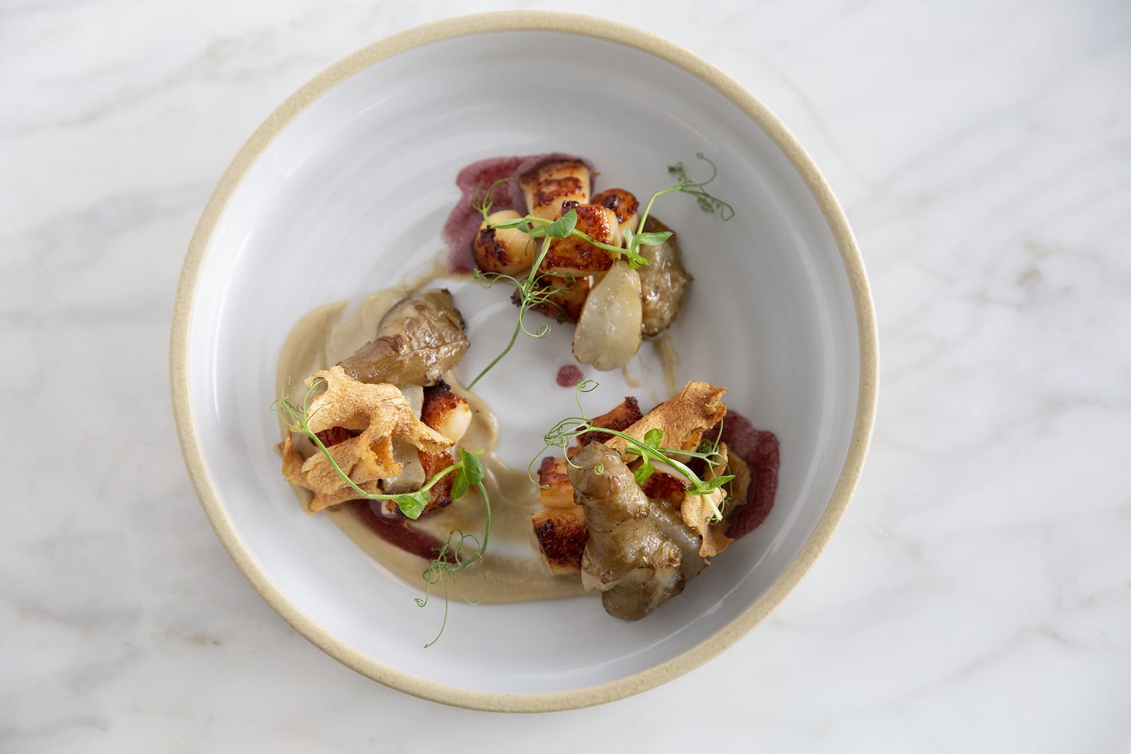 Nantucket Bay Scallops with Leeks and Black Truffle Vinaigrette is a simple dish that chef Anne Quatrano says expresses the importance of great ingredients. (Courtesy of Amanda Greene)