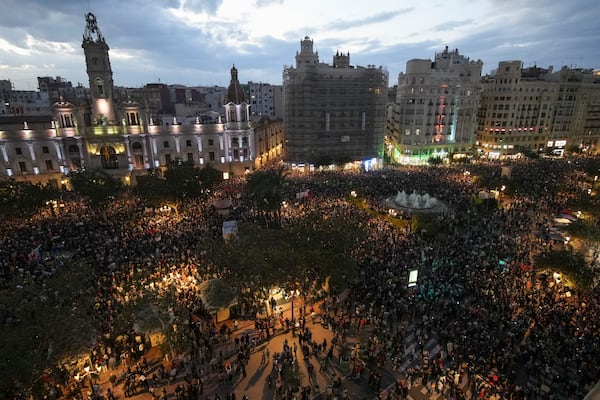 Thousands of demonstrators gather infant of the city council for a protest organized by social and civic groups, denouncing the handling of recent flooding under the slogan "Mazón, Resign," aimed at the president of the regional government Carlos Mazon, in Valencia, Spain, Saturday, Nov. 9, 2024. (AP Photo/Emilio Morenatti)