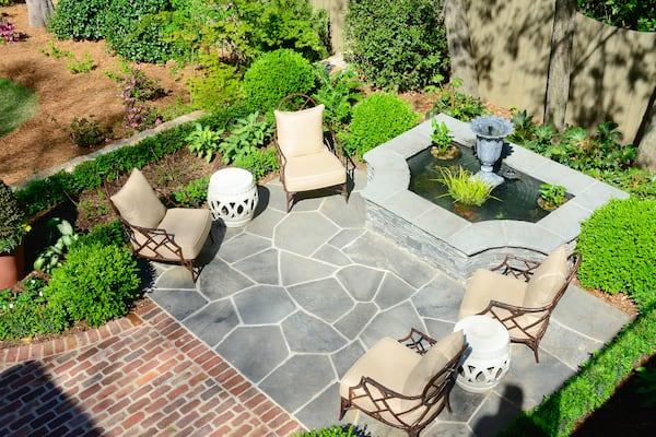 Landscape architect Richard Anderson re-envisioned the Brookwood Hills backyard with a bluestone patio and water feature in one section of the property.