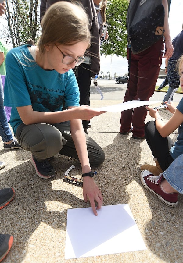 Adia Rico, 17, uses a pinhole projector to view the eclipse at the Northgate branch of the Chattanooga Public Library on Monday. (Photo Courtesy of Matt Hamilton)