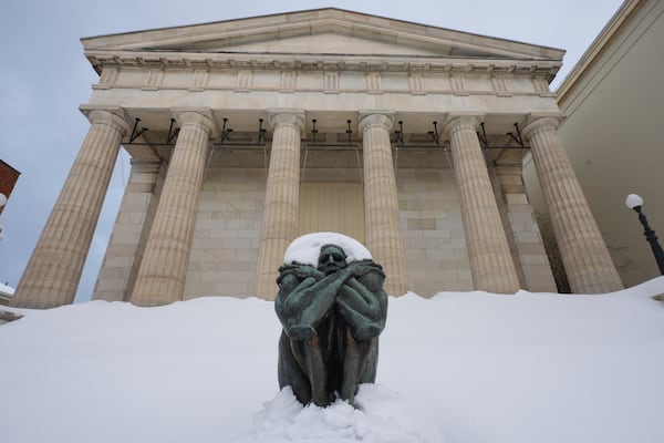 A sculpture is covered in snow on the steps of Erie Art Museum Tuesday, Nov. 5, 2024 in Erie, Pa. (AP Photo/Gene J. Puskar)