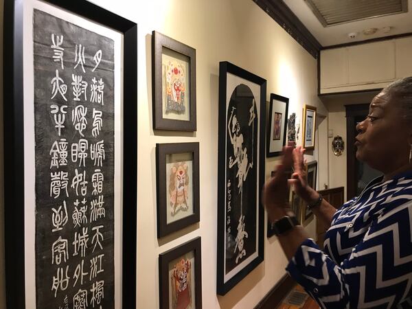 Jocelyn Dorsey shows some of her artwork she collected from years of travel overseas in the hallway of her West End home on Wednesday, July 18, 2018.