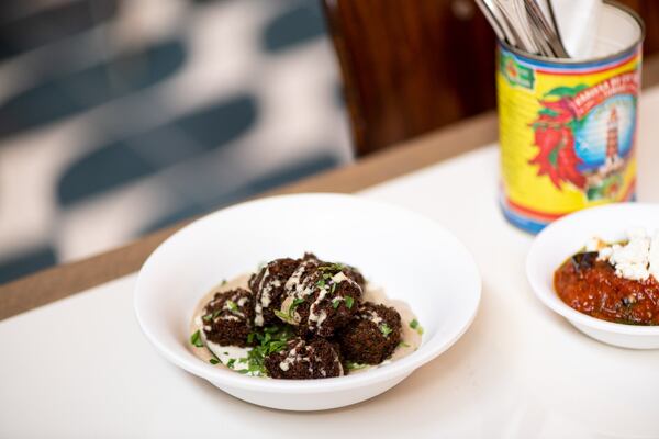 Falafel side with charred eggplant tahini and schug. Photo credit- Mia Yakel.