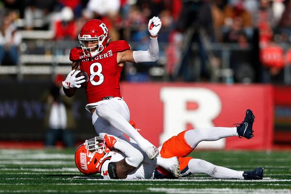 Rutgers wide receiver KJ Duff (8) makes a catch for a first down as Illinois defensive back Torrie Cox Jr. (5) makes the tackle during the first half of an NCAA college football game, Saturday, Nov. 23, 2024, in Piscataway, N.J. (AP Photo/Rich Schultz)