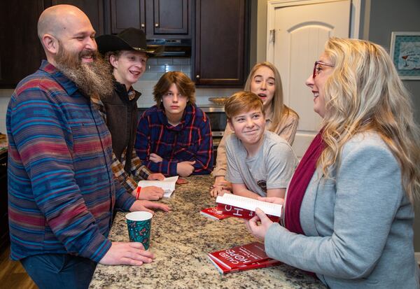 Joel Koeppen (from left), Breydan, Elijah, Avery and Hannah laugh at a story Sarah tells in their Dallas home. Sarah is the Founder and Executive Director of The Hope Box, a nonprofit that helps to stop abandonment of newborns by reaching out to moms in crisis. PHIL SKINNER FOR THE ATLANTA JOURNAL-CONSTITUTION.