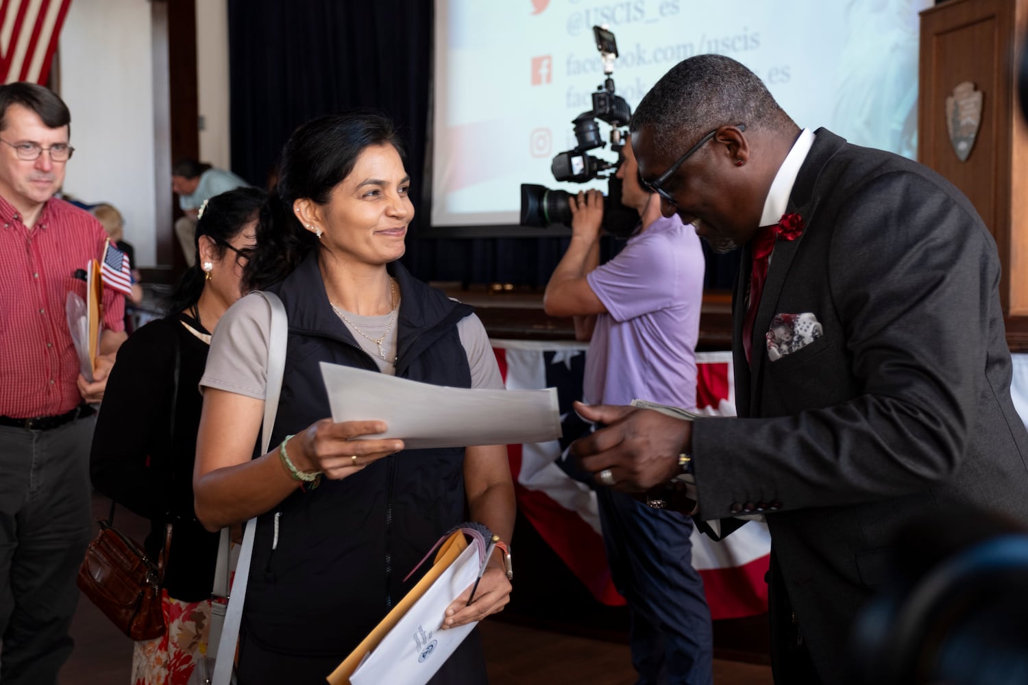 Zahra Rupani receives her Certificate of Naturalization from Dr. Rhomello Saddiq, supervisory immigration services officer for the U.S. Citizenship and Immigration Services department, following a Naturalization ceremony at Jimmy Carter National Historic Park in Plains on Tuesday, Oct. 1, 2024. The ceremony was held in honor of President Carter’s 100th birthday.  Ben Gray for the Atlanta Journal-Constitution