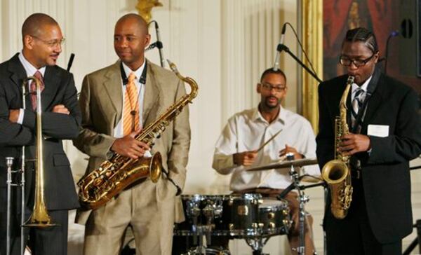 In a photo from 2009, trombonist Delfeayo Marsalis, saxophonist Branford Marsalis, and drummer Jason Marsalis listen as student Phillip Syle of New Orleans plays a solo during a jazz workshop in the East Room of the White House. CONTRIBUTED:  CHARLES DHARAPAK/AP