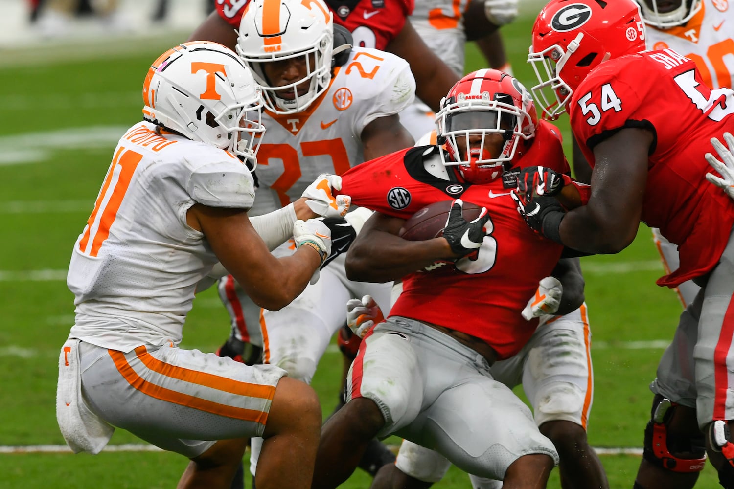 Georgia running back Zamir White is grabbed by Tennessee linebacker Henry To'o To’o, left, during the second half of a football game Saturday, Oct. 10, 2020, at Sanford Stadium in Athens. Georgia won 44-21. JOHN AMIS FOR THE ATLANTA JOURNAL- CONSTITUTION