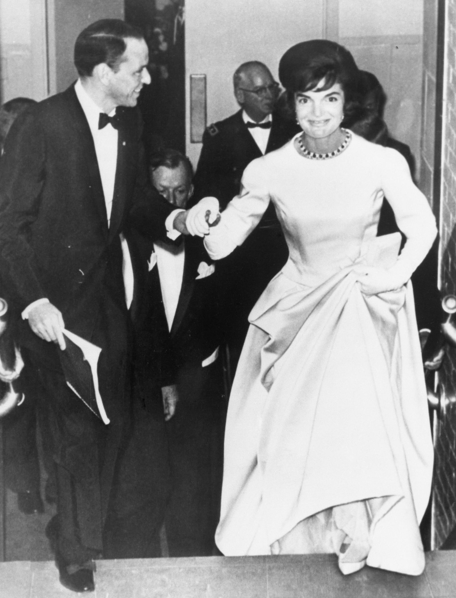 Singer Frank Sinatra escorts Jacqueline Kennedy, wife of the president-elect, into the National Guard Armory in Washington, D.C, on Jan 19, 1961, on her arrival to attend the inaugural gala. (AP Photo)