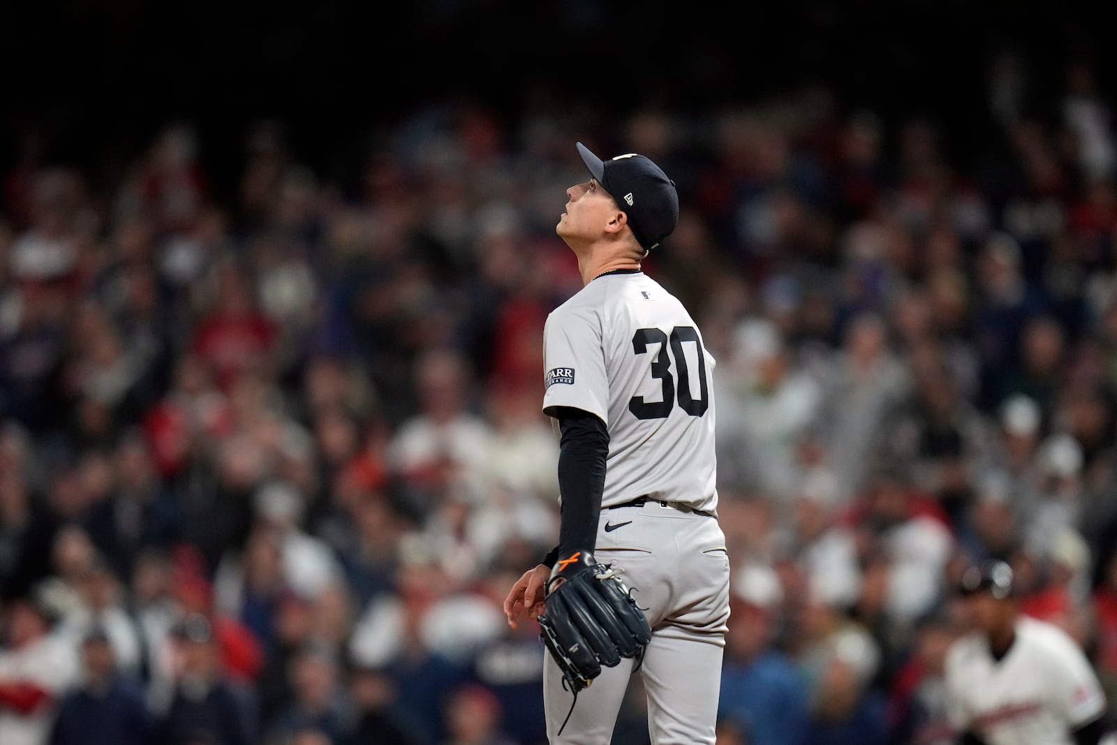 New York Yankees pitcher Luke Weaver watches a two-run home by Cleveland Guardians' Jhonkensy Noel during the ninth inning in Game 3 of the baseball AL Championship Series Thursday, Oct. 17, 2024, in Cleveland. (AP Photo/Jeff Roberson)