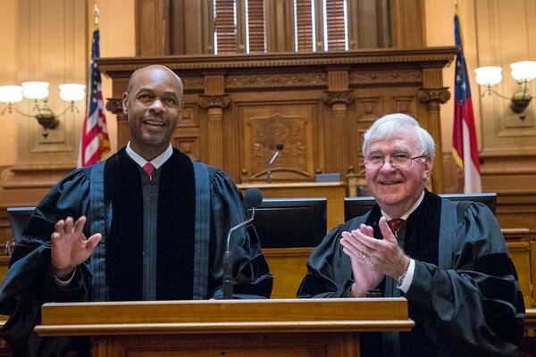 Newly sworn in Georgia Supreme Court Chief Justice Harold D. Melton (left) is applauded by former Chief Justice Harris Hines, who died Sunday in a car accident, during the official oath taking ceremony at the State Capitol in September. On Monday, Melton called Hines “a mentor and one of my dearest friends.” (ALYSSA POINTER/ALYSSA.POINTER@AJC.COM)