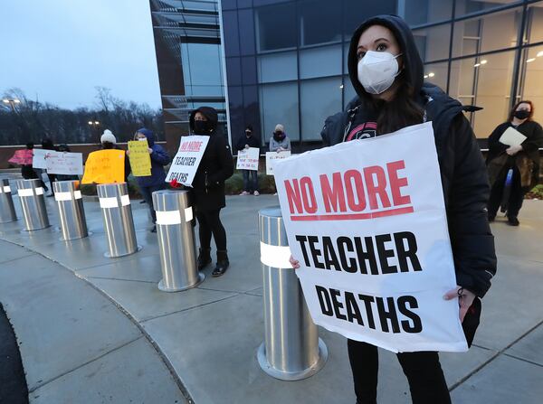 In this file photo, school counselor Jennifer Susko (right) is one of hundreds of Cobb County teachers and staff holding a protest in the parking lot during the school board meeting at the Cobb County School District's Offices. Cobb teachers are pressing the district for  an improved COVID-19 response.  Curtis Compton / Curtis.Compton@ajc.com”