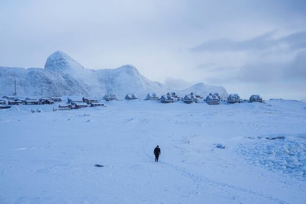 A woman walks on a beach in Nuuk, Greenland, March 4, 2025. (AP Photo/Evgeniy Maloletka)