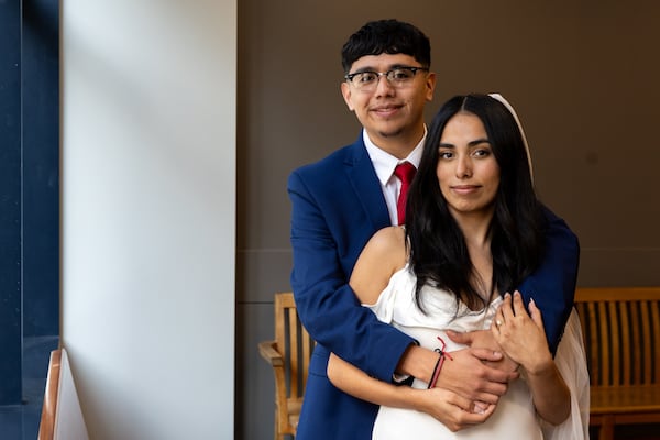 Adalberto Mendez and Vanessa Rodriguez pose for a portrait after a group Valentine’s Day wedding at Fulton County Courthouse in Atlanta on Friday, February 14, 2025. (Arvin Temkar / AJC)