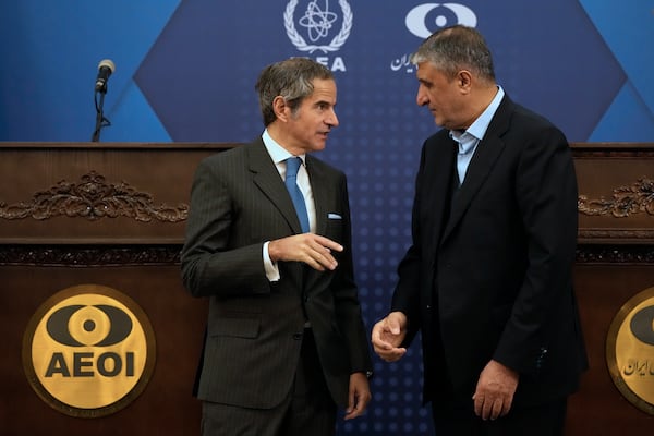 International Atomic Energy Agency, IAEA, Director General Rafael Mariano Grossi, left, talks with Iran's Atomic Energy Organization head Mohammad Eslami at the conclusion of their press conference in Tehran, Iran, Thursday, Nov. 14, 2024. (AP Photo/Vahid Salemi)