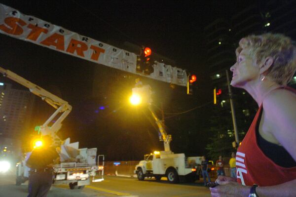 Julia Emmons was a key to the success of The Atlanta Journal-Constitution Peachtree Road Race for more than 20 years. She is seen here in a photo from 2006, at the pre-dawn starting line, preparing to run the race for the last time.  (ANDY SHARP/AJC file)