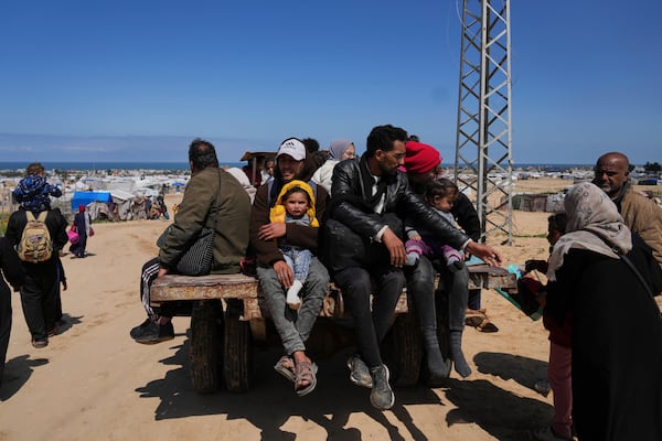 Displaced Palestinians, who flee from Rafah amidst ongoing Israeli military operations following Israel's renewed offensive in the Gaza Strip, arrive in Khan Younis, Gaza, on Sunday, March 23, 2025. (AP Photo/Abdel Kareem Hana)