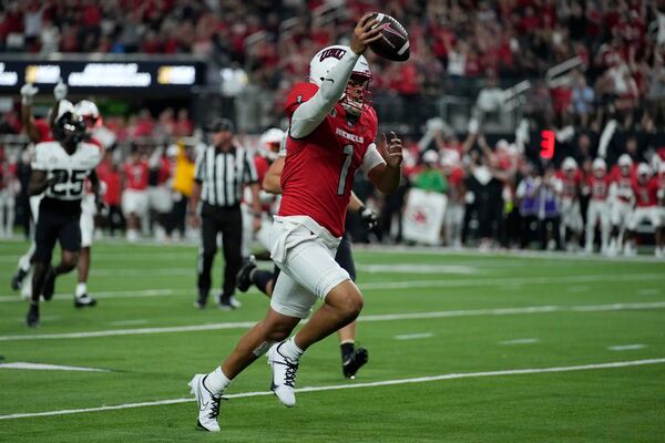 UNLV quarterback Jayden Maiava (1) celebrates as he runs in for a touchdown against the Vanderbilt during the second half of an NCAA college football game Saturday, Sept. 16, 2023, in Las Vegas. (AP Photo/John Locher)