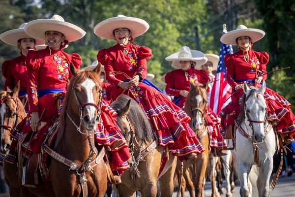 Participants in the Taste Of  Mableton Festival parade head down Floyd Rd  Saturday, April 15, 2023.  (Steve Schaefer/steve.schaefer@ajc.com)