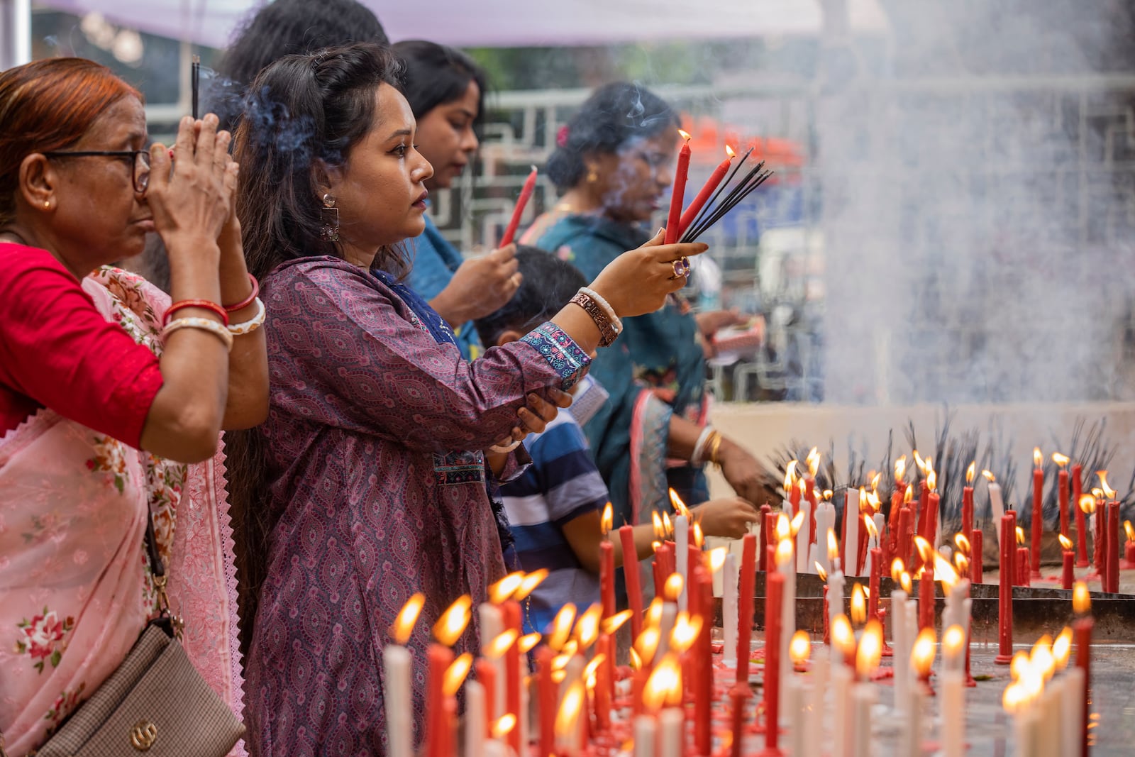 Hindu devotees offer prayers at the Dhakeshwari National Temple during the Durgapuja festival in Dhaka, Bangladesh, on Oct. 10, 2024. (AP Photo/Rajib Dhar)