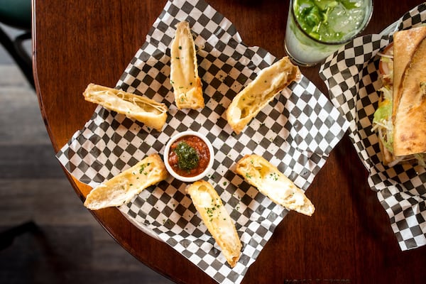 Black Sheep Tavern and Oyster Room Wonton Mozzarella Sticks with fresh mozzarella, marinara, and pesto. Photo credit- Mia Yakel.