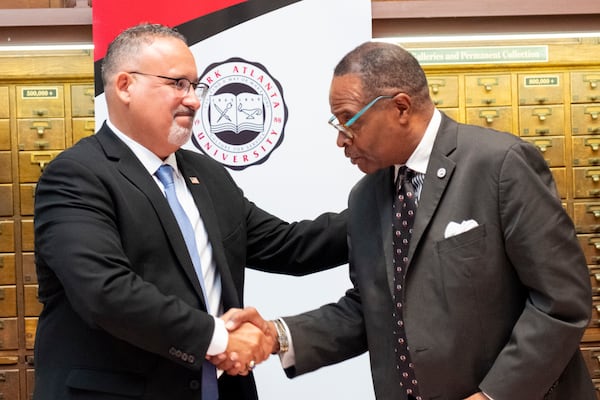 U.S. Secretary of Education Miguel Cardona shakes hands with Clark Atlanta University President George T. French, Jr. during a visit to Clark Atlanta University and Spelman College in Atlanta on Wednesday, July 17, 2024. President-elect Donald Trump has talked about abolishing the U.S. Department of Education. (Ben Gray / Ben@BenGray.com)