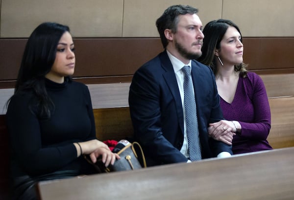 Jenna Garland, right, and her husband, Simeon Spearman, sit next to Anne Torres, Garland’s former boss and former Mayor Kasim Reed’s director of communications, during a pre-trial hearing Monday in the Fulton County Courthouse. Garland has been charged with two misdemeanor counts of violating the Georgia Open Records Act. STEVE SCHAEFER / SPECIAL TO THE AJC