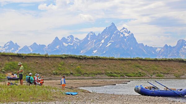 A family of rafters takes a lunch break while drifting on the Snake River in Grand Teton National Park. (Dennis Anderson/Minneapolis Star Tribune/TNS)