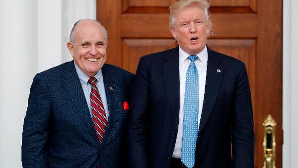 FILE - In this Nov. 20, 2016, file photo, then-President-elect Donald Trump, right, and former New York Mayor Rudy Giuliani pose for photographs as Giuliani arrives at the Trump National Golf Club Bedminster clubhouse in Bedminster, N.J. (AP Photo/Carolyn Kaster, File)