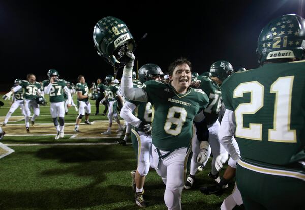 November 7, 2014 - Roswell, Ga: Blessed Trinity fullback Jake Bogosian (8) celebrates with teammates after their win over Cedar Grove Friday November 7, 2014, in Roswell, Ga.. Blessed Trinity won 28-21 to win the region championship. JASON GETZ / SPECIAL