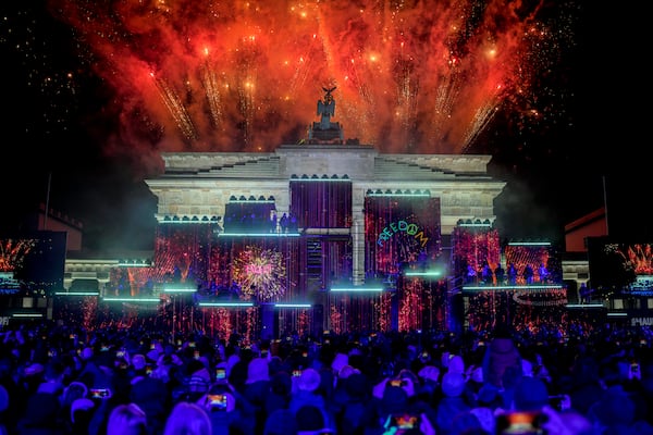 Fireworks light the sky during the as musicians play on stage during the concert for freedom for the 35th anniversary of the fall of the Berlin Wall, in Berlin, Germany, Saturday, Nov. 9, 2024. (AP Photo/Ebrahim Noroozi)