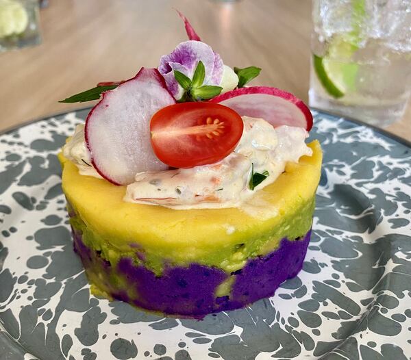 At a recent pop-up dinner at Silver Queen restaurant in Monroe,  La Chingana chef Arnaldo Castillo served this Peruvian causa, layered with purple potato, avocado, white potato and shrimp salad. Wendell Brock for The Atlanta Journal-Constitution