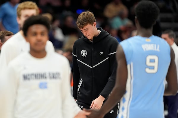 Duke forward Cooper Flagg walks to the bench during the first half of an NCAA college basketball game against North Carolina in the semifinals of the Atlantic Coast Conference tournament, Friday, March 14, 2025, in Charlotte, N.C. Flagg and was injured yesterday. (AP Photo/Chris Carlson)