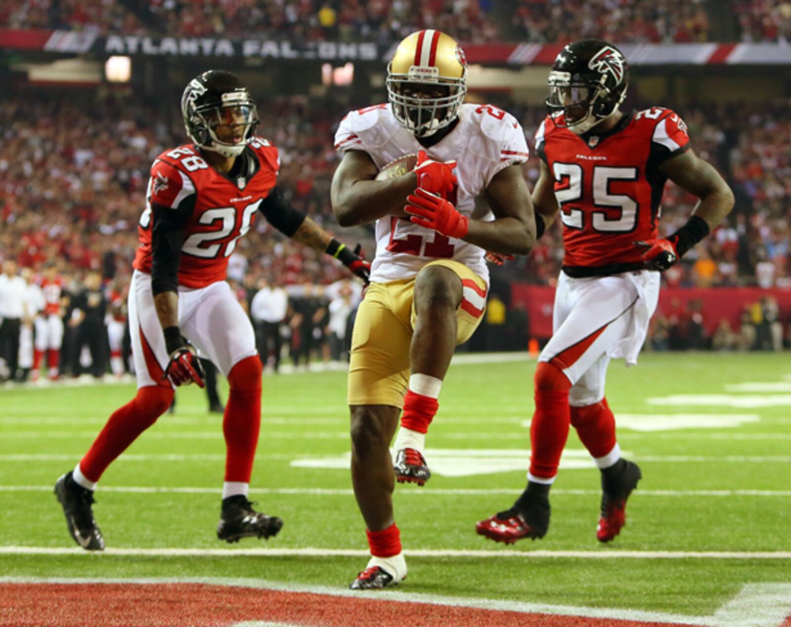 Frank Gore slips through the Falcons defense to give the 49ers a 28-24 lead late in the fourth quarter of the NFC Championship Game at the Georgia Dome.