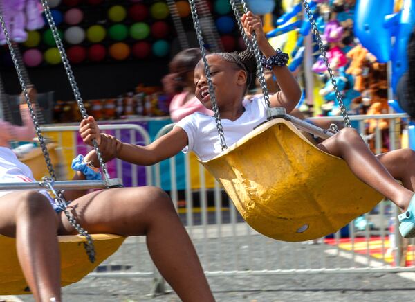 People enjoy the rides at the Atlanta Fair near the old Turner Field on Sunday, March 6, 2022. This was the opening weekend for the annual fair that runs through April 10. (Photo by Steve Schaefer for The Atlanta Journal-Constitution)