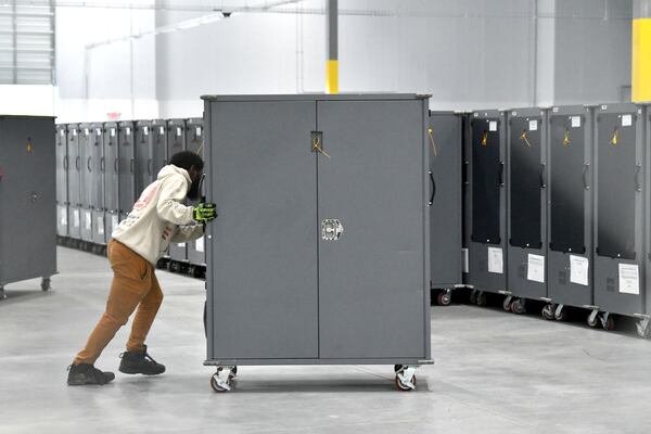 Workers are setting up equipment in early voting and ballot counting storage area at new Fulton County Election Hub and Operation Center, Tuesday, July 11, 2023, in Fairburn. (Hyosub Shin / Hyosub.Shin@ajc.com)