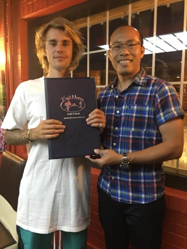 Justin Bieber grins next to Fuji Hana East Cobb manager Daniel Wu on Sunday. (Courtesy of Fuji Hana East Cobb)