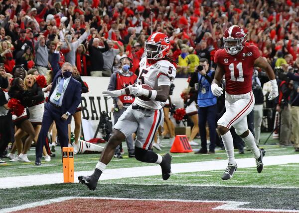 Georgia defensive back Kelee Ringo intercepts Alabama and returns it for a touchdown for a 33-18 lead and victory over Alabama in the College Football Playoff Championship game on Monday, Jan. 10, 2022, in Indianapolis. (Curtis Compton/The Atlanta Journal-Constitution/TNS)