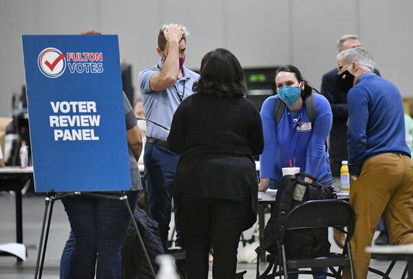 Members of Voter Review Panel confer as Fulton County's members of a recount team work on hand recount and audit of ballots during Fulton County's Risk Limiting Audit process at Georgia World Congress Center on Saturday, November 14, 2020. (Hyosub Shin/Atlanta Journal-Constitution/TNS)