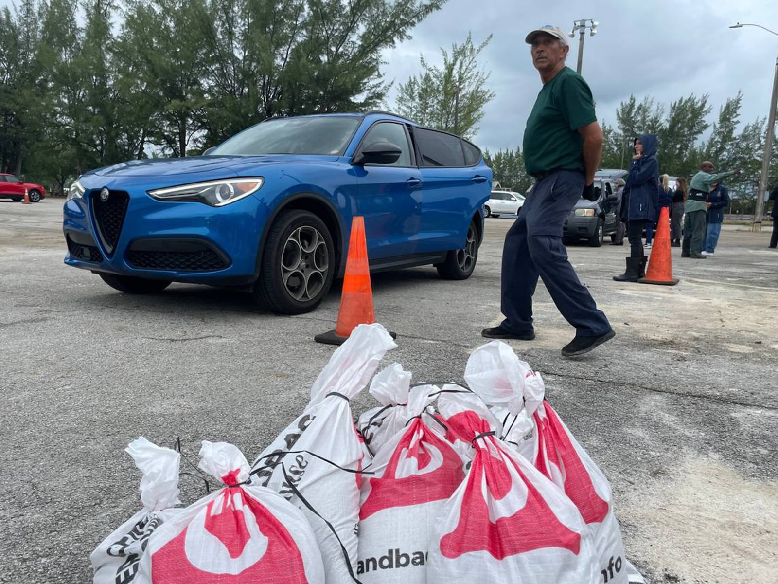 People waited in line for nearly two hours Monday at Tropical Park in Miami to get four free sandbags in preparation for Hurricane Milton.