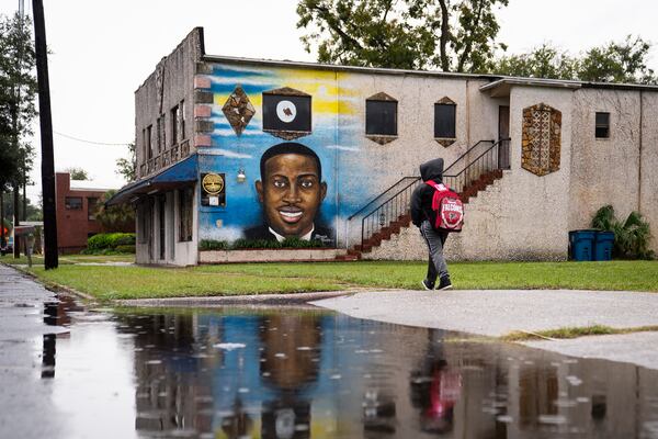 A mural of Ahmaud Arbery by the artist Marvin Weeks on a building that will soon be the site of the Brunswick African American Cultural Center near the Glynn County Courthouse in Brunswick, Ga., Nov. 5, 2021. Opening arguments in the trial over the killing of Arbery by three white men began on Friday morning in Brunswick, a community made uneasy this week by the selection of a nearly all-white jury to hear the case. (Nicole Craine/The New York Times)