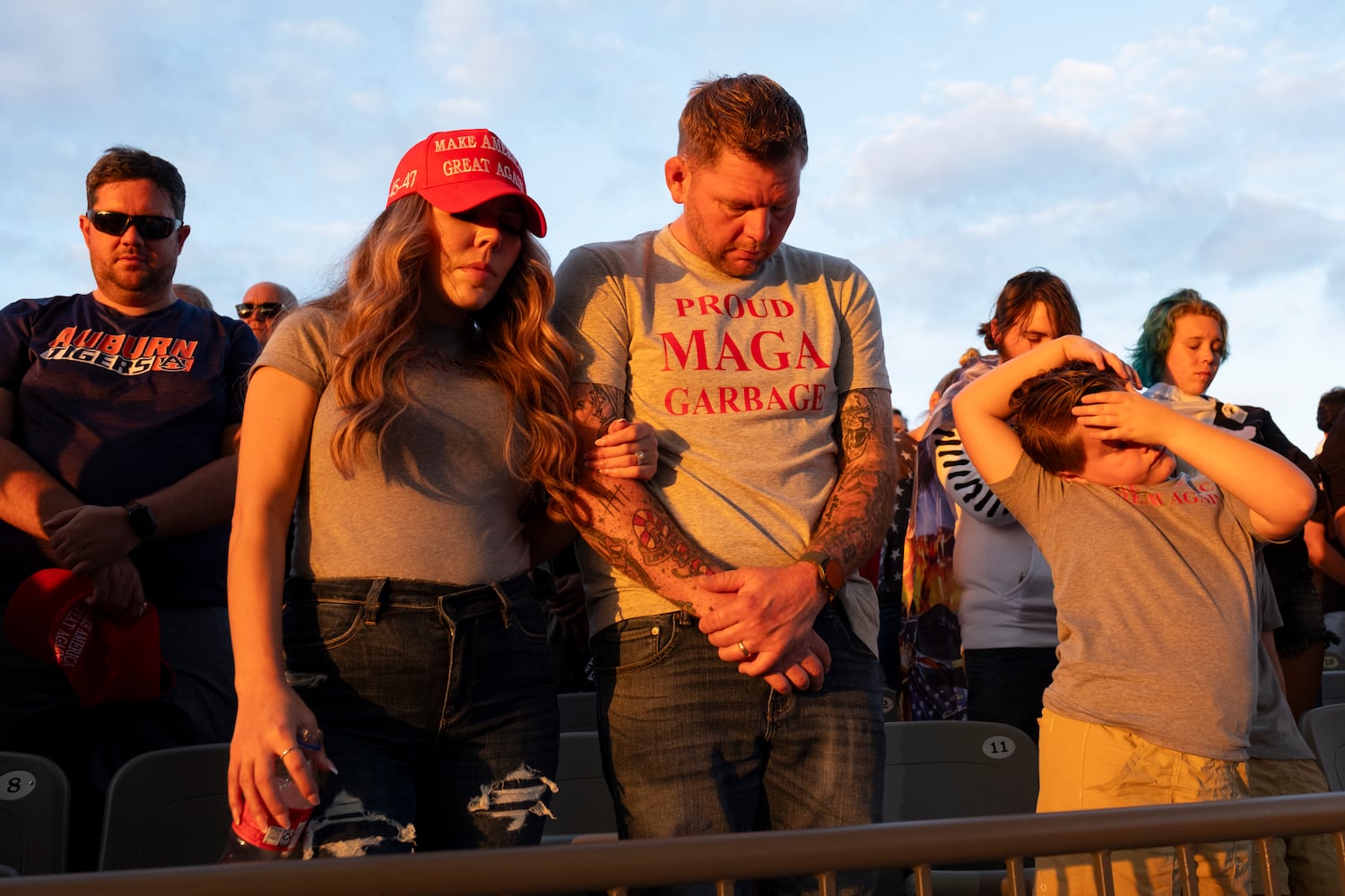 People bow their heads in prayer at the start of a rally for former President Donald Trump in Macon on Sunday, Nov. 3, 2024.   Ben Gray for the Atlanta Journal-Constitution