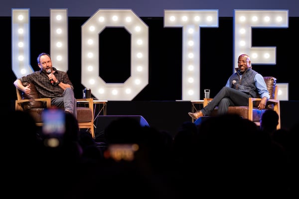 Singer Dave Matthews, left, talks with Democratic U.S. Sen. Raphael Warnock before a performance Monday evening at the Coca-Cola Roxy. The event was aimed at white suburbanites, a key part of the coalition Warnock is relying on in pursuit of reelection. Ben Gray for The Atlanta Journal-Constitution