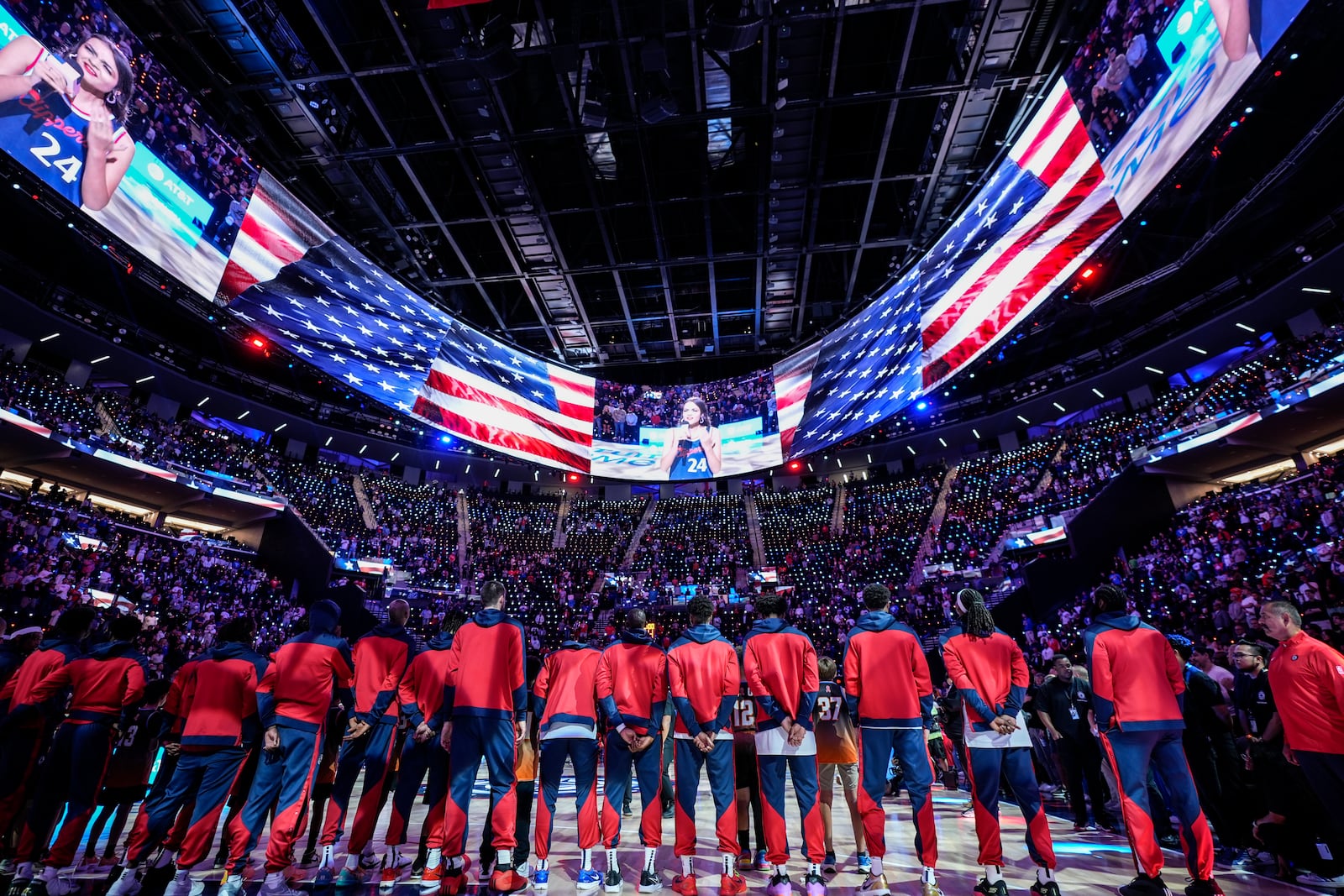 Los Angeles Clippers players listen to the national anthem before an NBA preseason basketball game against the Dallas Mavericks at Intuit Dome in Inglewood, Calif., Monday, Oct. 14, 2024. (AP Photo/Jae C. Hong)