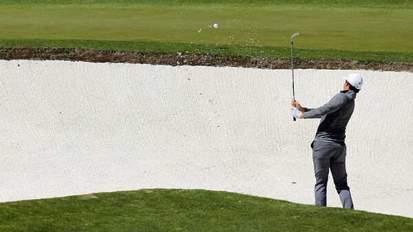 Rory McIlroy plays a shot from a bunker on the fourth hole for double bogey during the second round of the 80th Masters Friday, April 8, 2016, at the Augusta National Golf Club in Augusta.