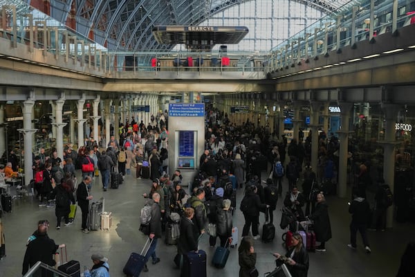 Passengers queue and wait near departures for Eurostar services at St Pancras International station in London, Friday March 7, 2025, after Eurostar trains to the capital have been halted following the discovery of an unexploded Second World War bomb near the tracks in Paris. (AP Photo/Frank Augstein)