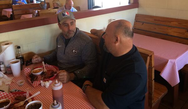 When Emerson Fromm, left, and Richard Martin sit down over a plate of meat at Martin's BBQ, the conversation ranges from football to hunting. (Steve Hummer/shummer@ajc.com)