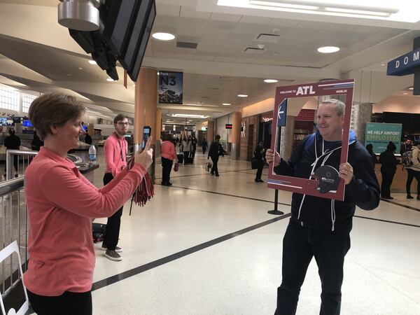 Mischelle Curtin takes a photo of NFL Volunteer Appreciation team member Michael Posluszny. ARLINDA SMITH BROADY/AJC