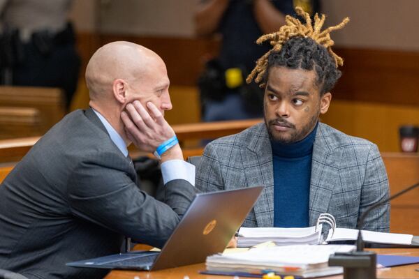 (R-L) Attorney Maxwell Schardt speaks to his client Shannon Stillwell at a hearing on the YSL case in Atlanta on Thursday, December 22, 2022. (Arvin Temkar / arvin.temkar@ajc.com)